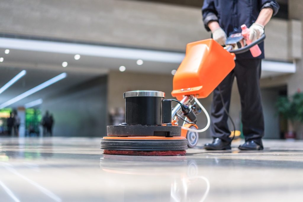 Cleaning the floor using a machine
