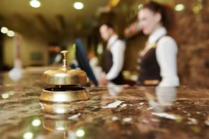 Desk bell with hotel concierge as background