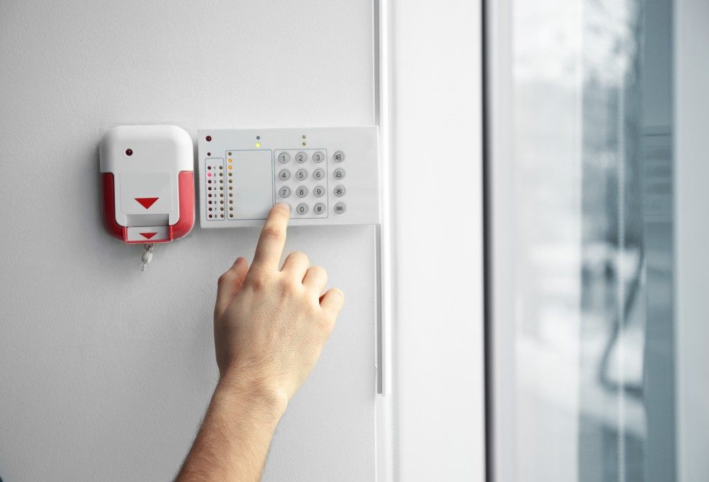 Security alarm keypad with male hand