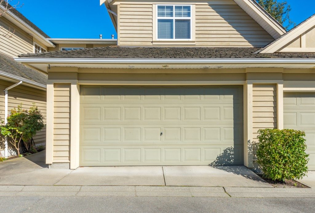 homes's garage with a green pale door color