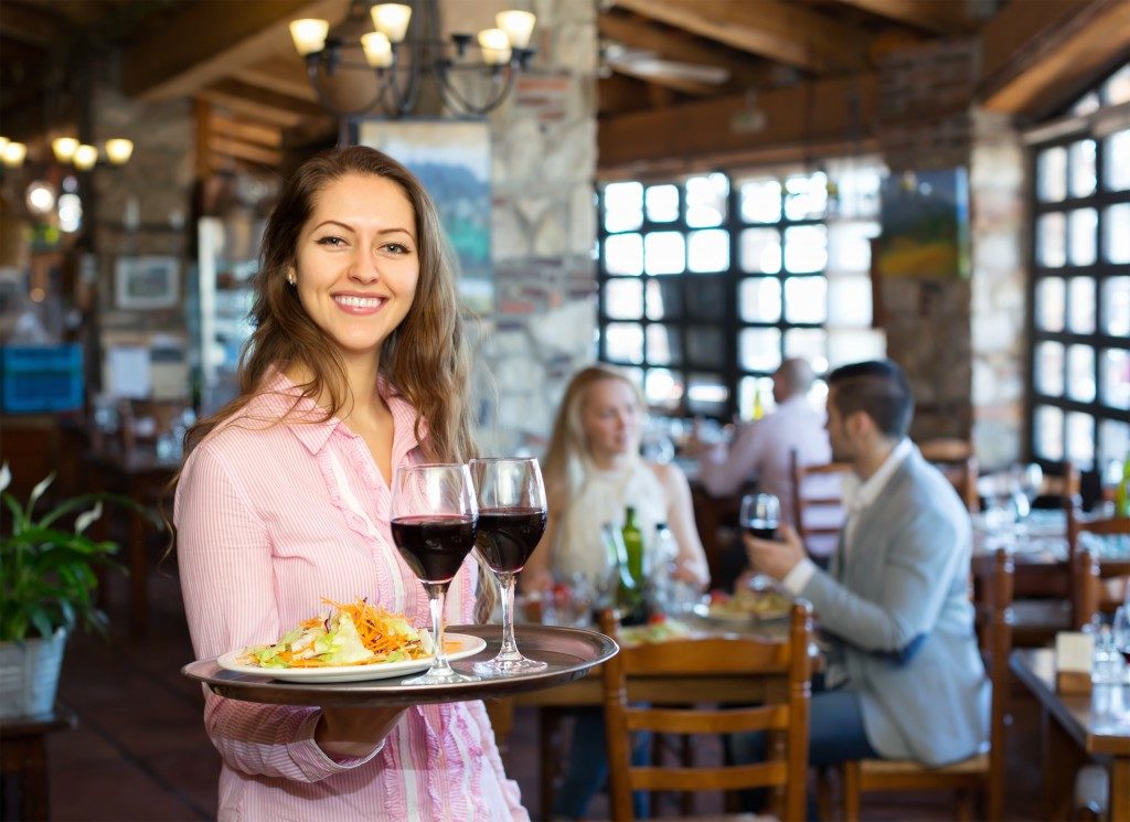 Woman serving food and wine