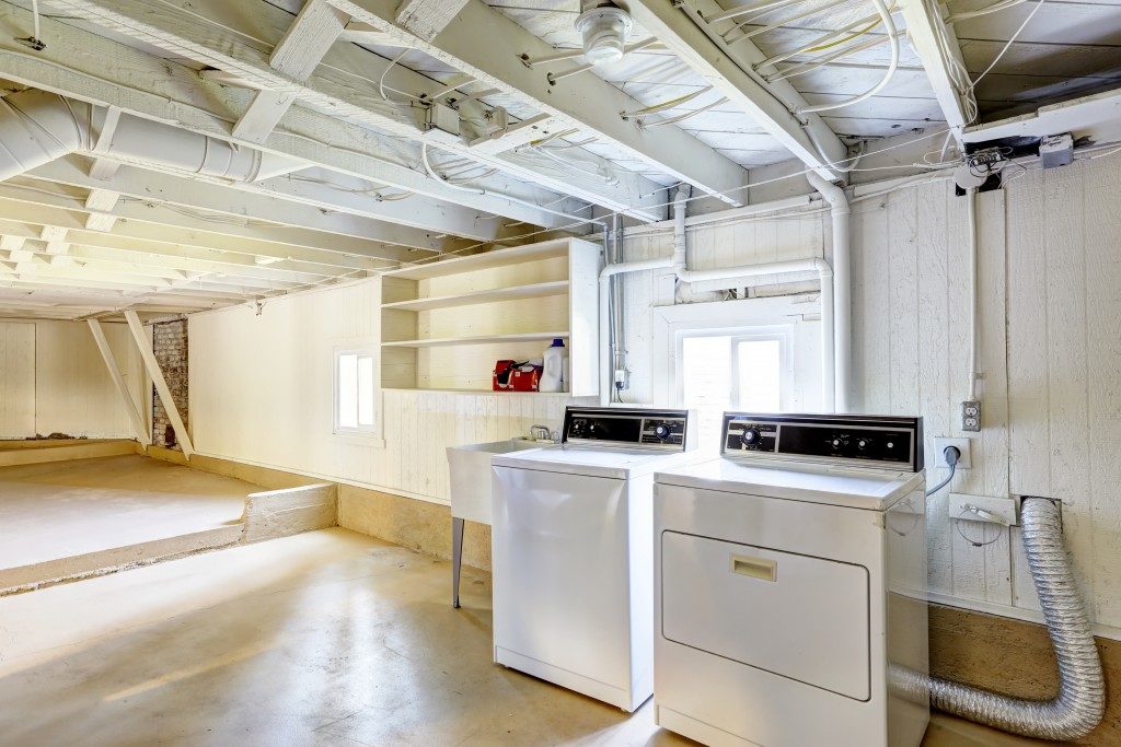 Spacious empty basement with laundry