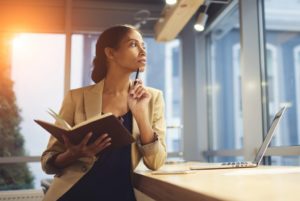 entrepreneur holding her notebook and pen