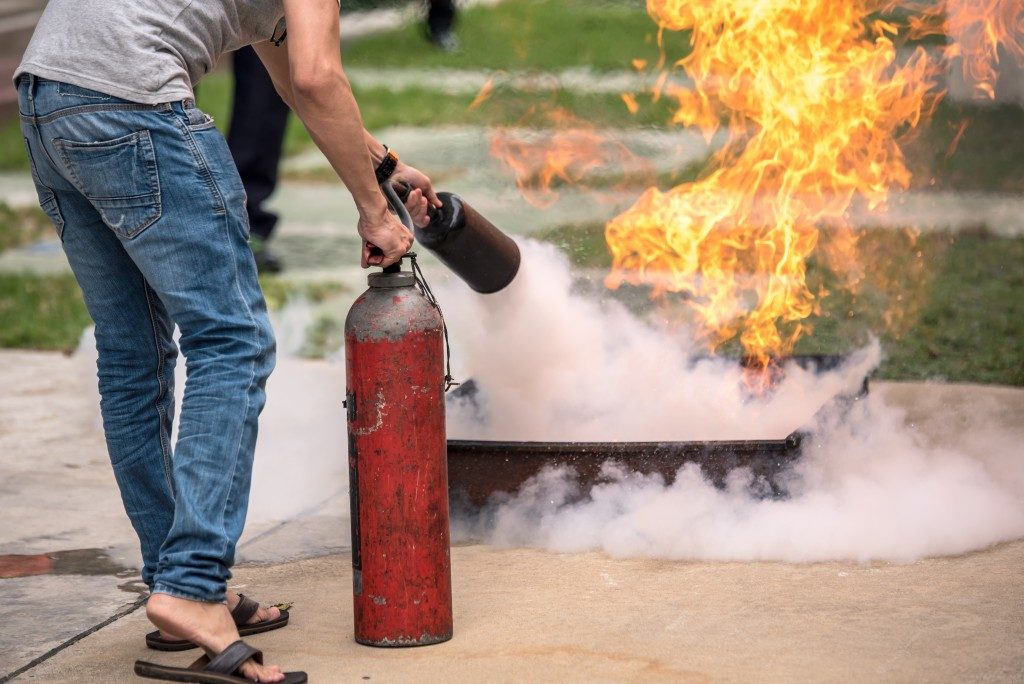 person taught to extinguish fire