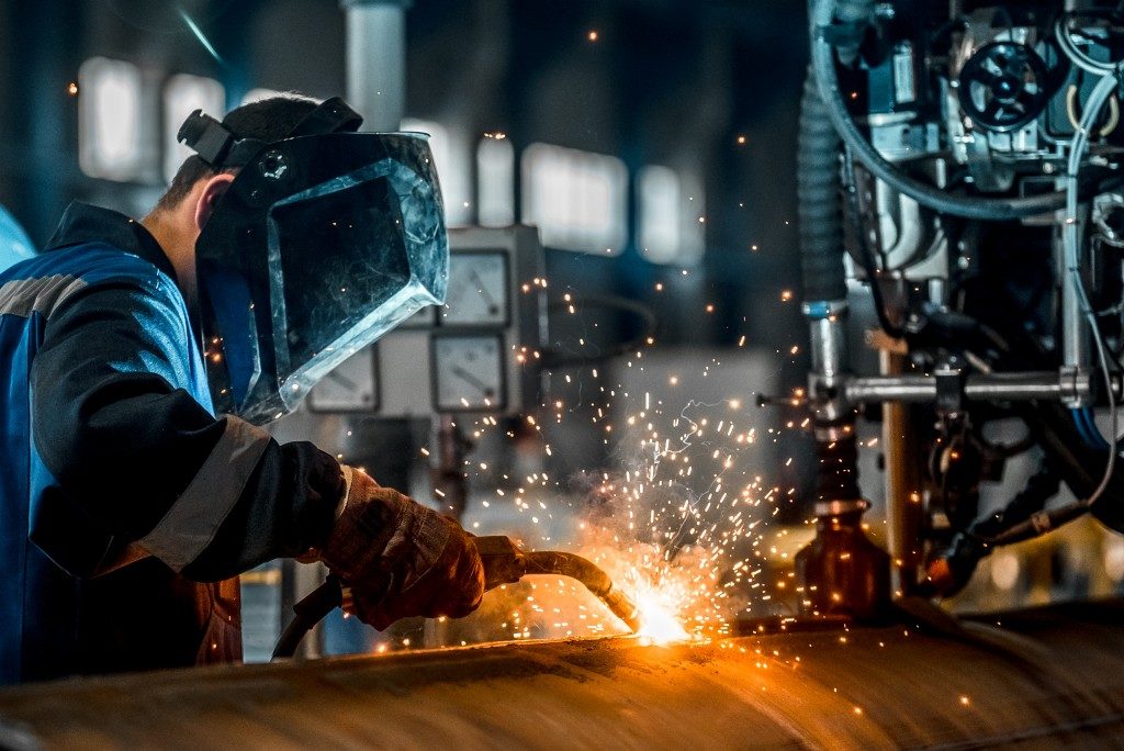 Man in safety gear welding metal