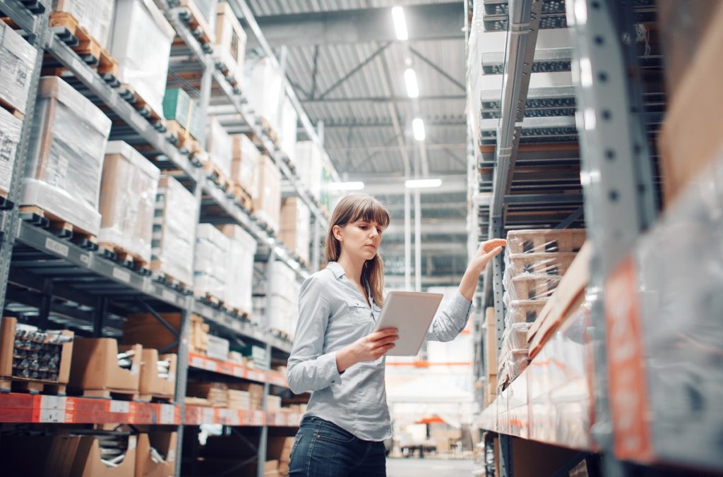 Woman checking inventory in warehouse
