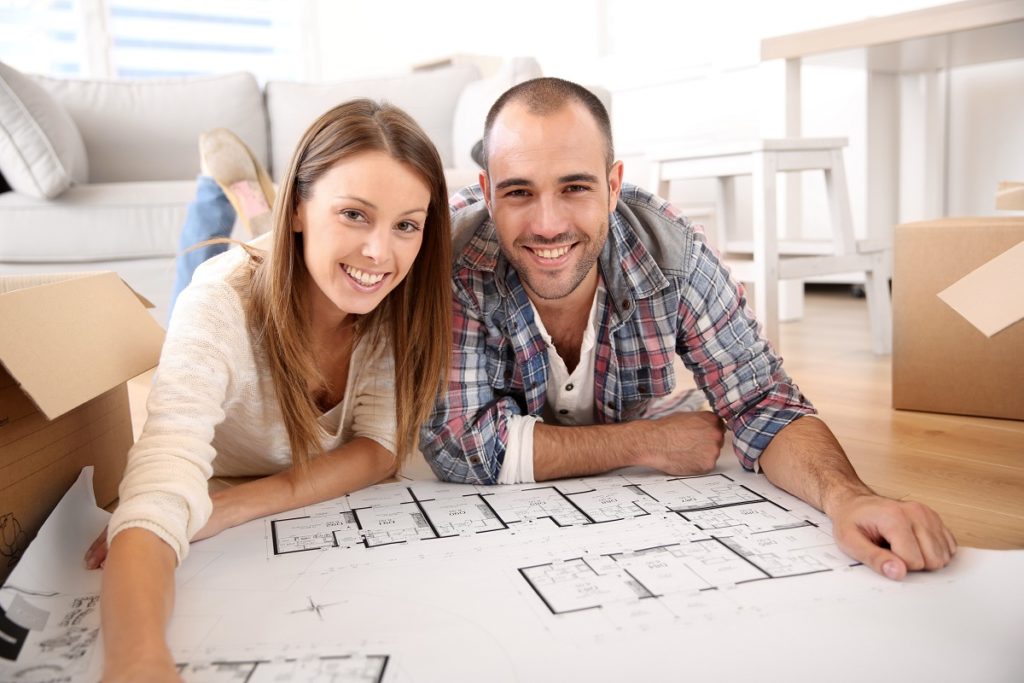 couple looking at their house floor plan