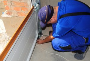 man installing a garage door