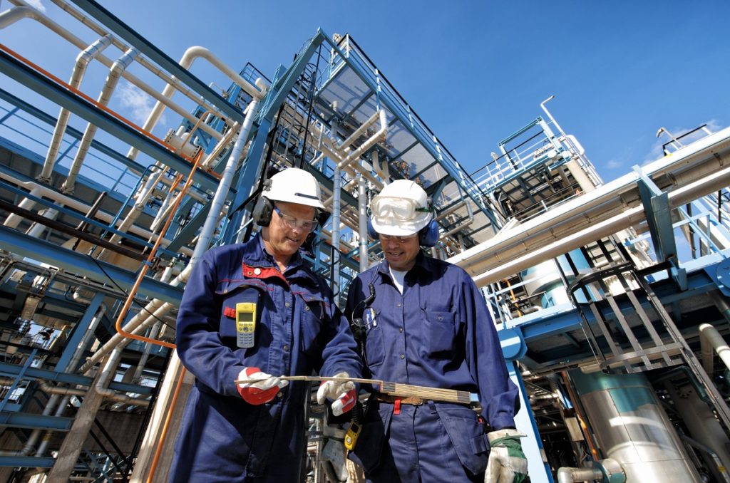 Oil plant workers wearing safety gear