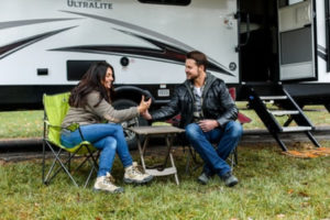 man and woman next to an RV