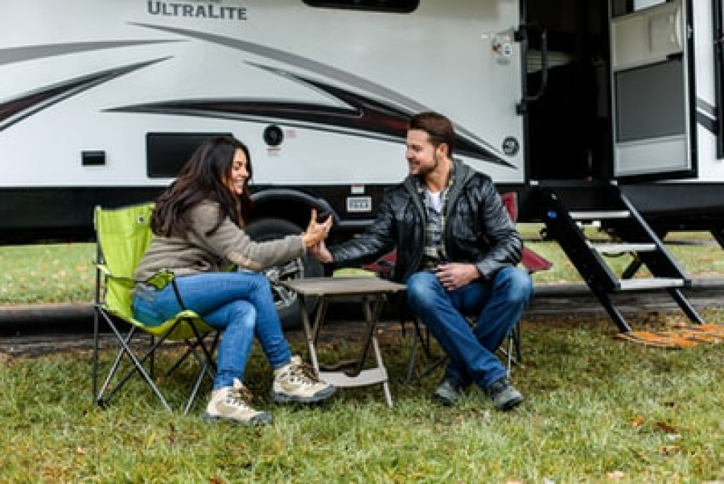 man and woman next to an RV