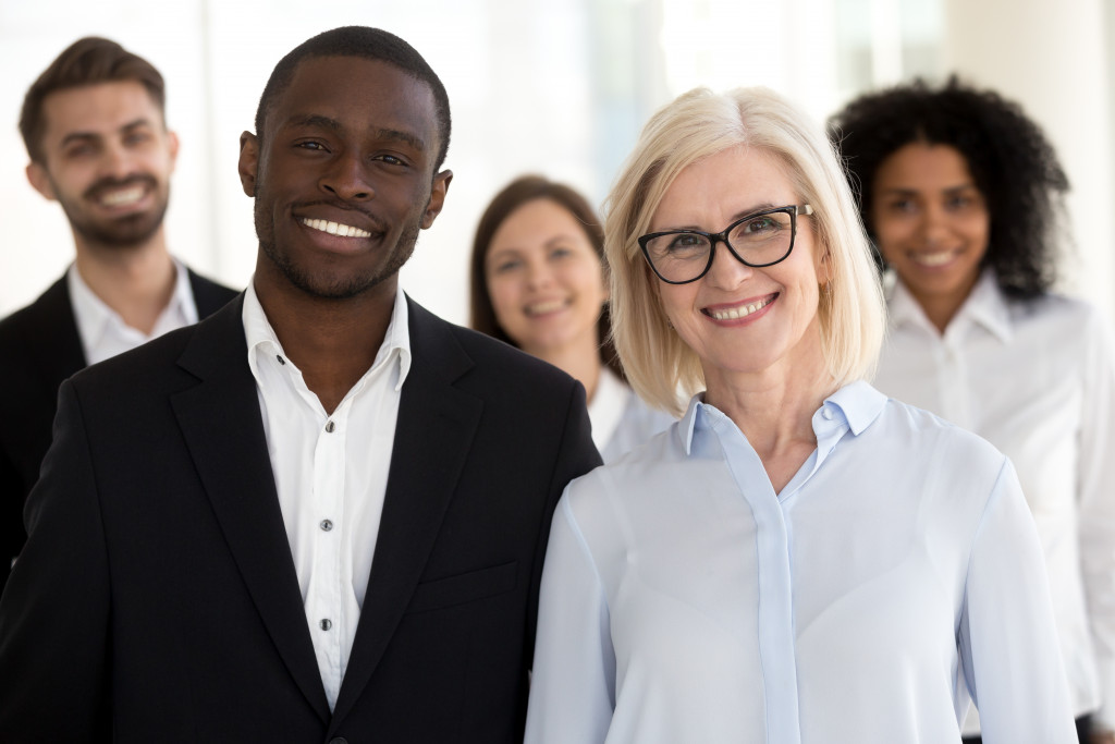 smiling multiracial executive partners, african caucasian company staff