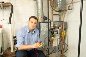 a plumber making furnace repairs