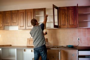 man fixing the kitchen cabinet