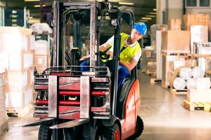 a man operating a forklift in the warehouse